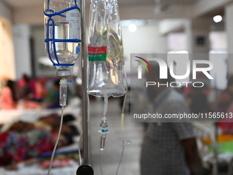 Patients suffering from dengue fever receive treatment inside the Mugdha General Hospital's admission section in Dhaka, Bangladesh, on Septe...