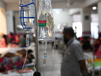 Patients suffering from dengue fever receive treatment inside the Mugdha General Hospital's admission section in Dhaka, Bangladesh, on Septe...