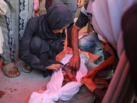 Palestinians mourn 6-year-old Palestinian girl Fatmah Juma, who is killed by an Israeli airstrike that hits their family house in Bureij Cam...