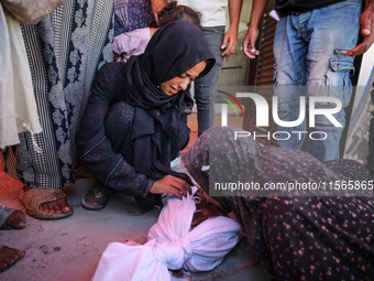 Palestinians mourn 6-year-old Palestinian girl Fatmah Juma, who is killed by an Israeli airstrike that hits their family house in Bureij Cam...