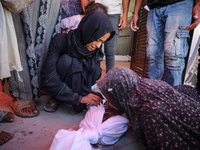 Palestinians mourn 6-year-old Palestinian girl Fatmah Juma, who is killed by an Israeli airstrike that hits their family house in Bureij Cam...