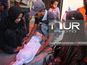 Palestinians mourn 6-year-old Palestinian girl Fatmah Juma, who is killed by an Israeli airstrike that hits their family house in Bureij Cam...