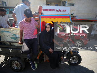 People perform a funeral prayer near the body of 6-year-old Palestinian girl Fatmah Juma, who is killed by an Israeli airstrike that hits th...