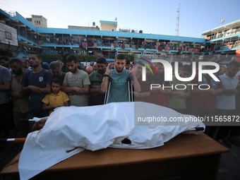 Palestinians check the grounds of a school after an Israeli air strike hits the site in Nuseirat, Gaza Strip, on September 11, 2024, amid th...