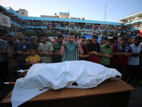 Palestinians check the grounds of a school after an Israeli air strike hits the site in Nuseirat, Gaza Strip, on September 11, 2024, amid th...