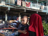 Palestinians check the grounds of a school after an Israeli air strike hits the site in Nuseirat, Gaza Strip, on September 11, 2024, amid th...