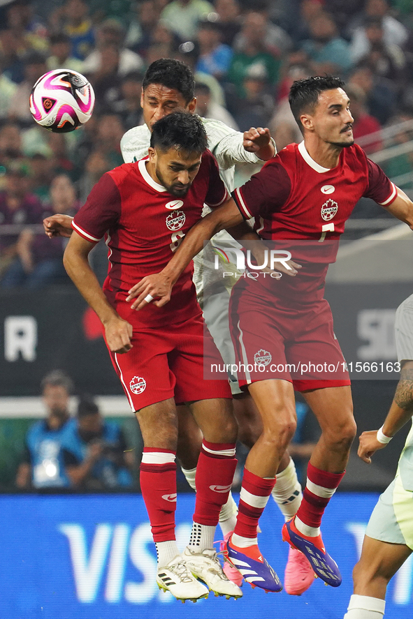 Estephen Eustaquio #7 and Mathieu Choiniere #8 of Canada jump for the header during the international friendly match between Mexico and Cana...