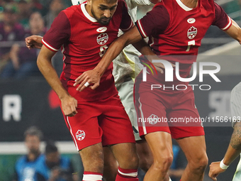 Estephen Eustaquio #7 and Mathieu Choiniere #8 of Canada jump for the header during the international friendly match between Mexico and Cana...