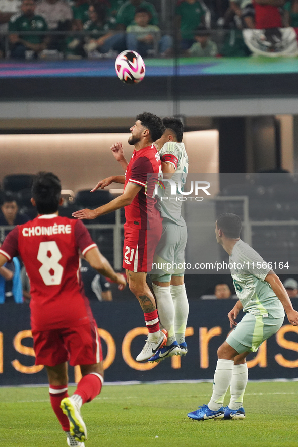 Jonathan Osorio #21 of Canada and Johan Vasquez #5 of Mexico jump for the header during the international friendly match between Mexico and...