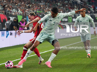 Liam Millar #23 of Canada and Luis Romo #7 of Mexico battle for the ball during the international friendly match between Mexico and Canada a...