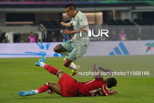 Derek Cornelius #13 of Canada slides to the ball against Roberto Alvarado #25 of Mexico during the international friendly match between Mexi...