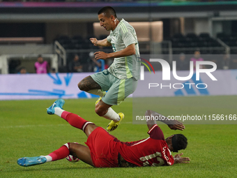 Derek Cornelius #13 of Canada slides to the ball against Roberto Alvarado #25 of Mexico during the international friendly match between Mexi...