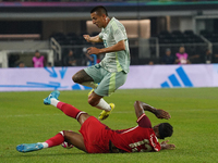 Derek Cornelius #13 of Canada slides to the ball against Roberto Alvarado #25 of Mexico during the international friendly match between Mexi...