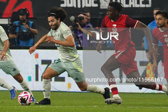 Cesar Huerta #21 of Mexico drives the ball forward during the international friendly match between Mexico and Canada at AT&T Stadium in Mexi...