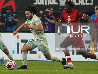 Cesar Huerta #21 of Mexico drives the ball forward during the international friendly match between Mexico and Canada at AT&T Stadium in Mexi...