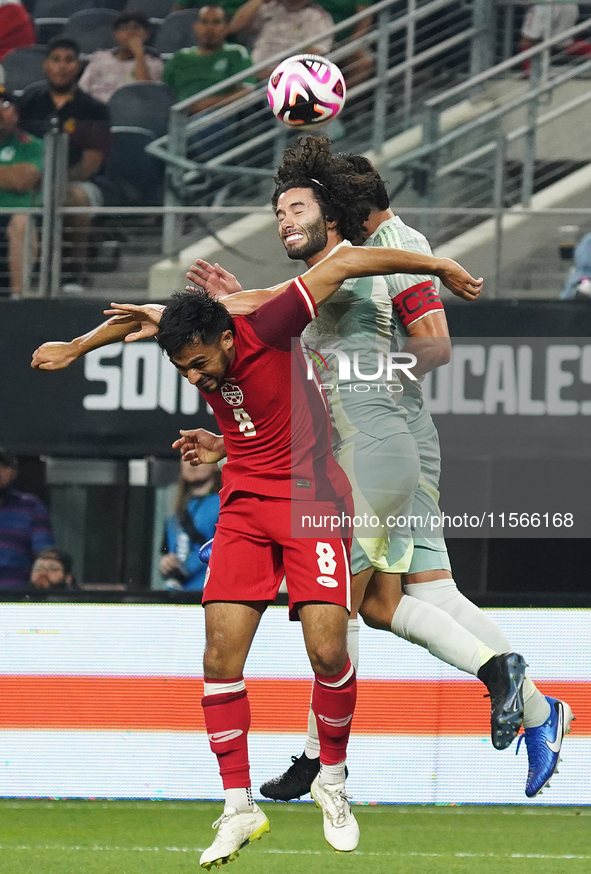 Cesar Huerta #21 of Mexico and Mathieu Choiniere #8 of Canada battle for the header during the international friendly match between Mexico a...