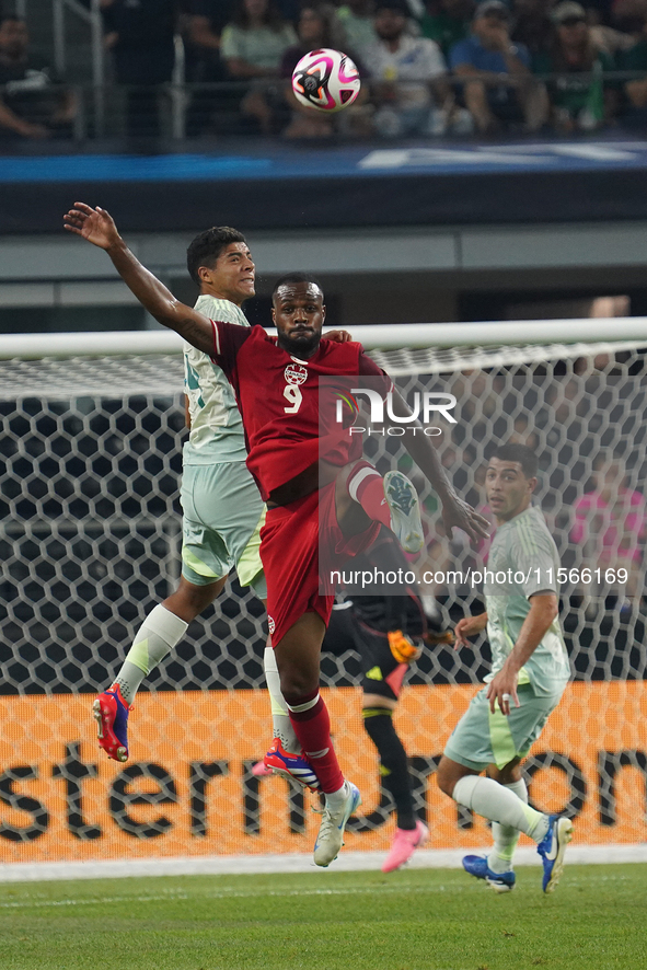 Victor Andres Guzman Olmedo #14 of Mexico and Cyle Larin #9 of Canada battle for the header during the international friendly match between...