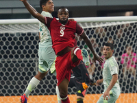 Victor Andres Guzman Olmedo #14 of Mexico and Cyle Larin #9 of Canada battle for the header during the international friendly match between...