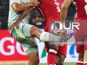 Victor Andres Guzman Olmedo #14 of Mexico and Cyle Larin #9 of Canada battle for the ball during the international friendly match between Me...