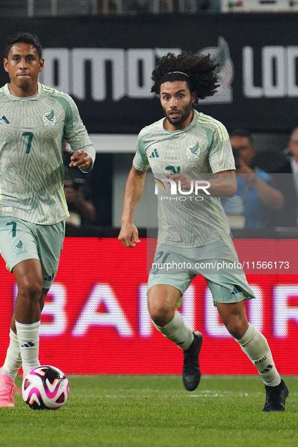 Cesar Huerta #21 of Mexico drives the ball forward during the international friendly match between Mexico and Canada at AT&T Stadium in Mexi...