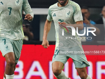 Cesar Huerta #21 of Mexico drives the ball forward during the international friendly match between Mexico and Canada at AT&T Stadium in Mexi...