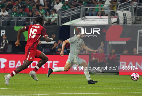 Cesar Huerta #21 of Mexico drives the ball forward during the international friendly match between Mexico and Canada at AT&T Stadium in Mexi...