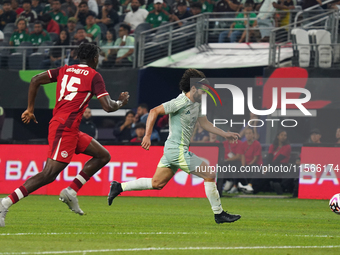 Cesar Huerta #21 of Mexico drives the ball forward during the international friendly match between Mexico and Canada at AT&T Stadium in Mexi...