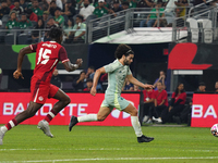 Cesar Huerta #21 of Mexico drives the ball forward during the international friendly match between Mexico and Canada at AT&T Stadium in Mexi...