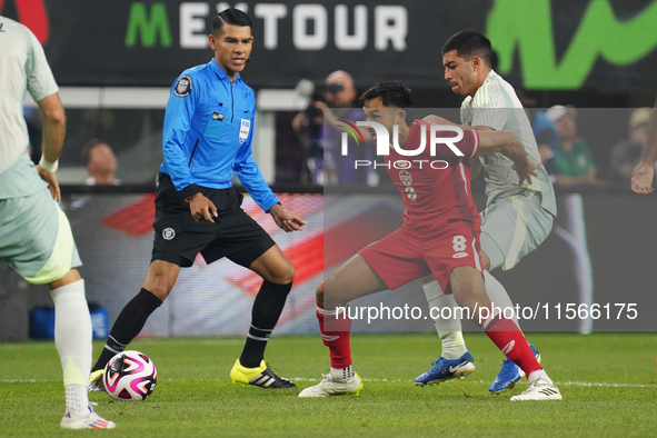 Mathieu Choiniere #8 of Canada battles for the ball during the international friendly match between Mexico and Canada at AT&T Stadium in Mex...