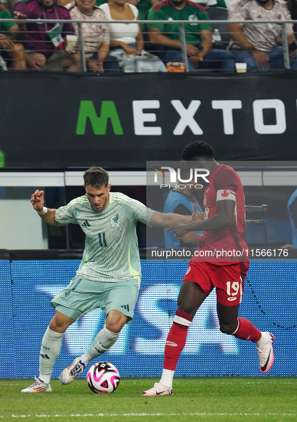 Alphonso Davies #19 of Canada and Santiago Gimenez #11 of Mexico battle for the ball during the international friendly match between Mexico...