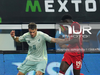 Alphonso Davies #19 of Canada and Santiago Gimenez #11 of Mexico battle for the ball during the international friendly match between Mexico...