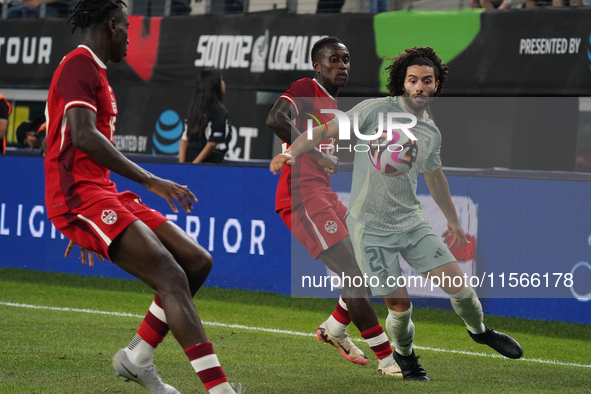 Cesar Huerta #21 of Mexico drives the ball forward during the international friendly match between Mexico and Canada at AT&T Stadium in Mexi...