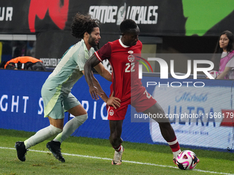 Cesar Huerta #21 of Mexico and Richie Laryea #22 of Canada battle for the ball during the international friendly match between Mexico and Ca...