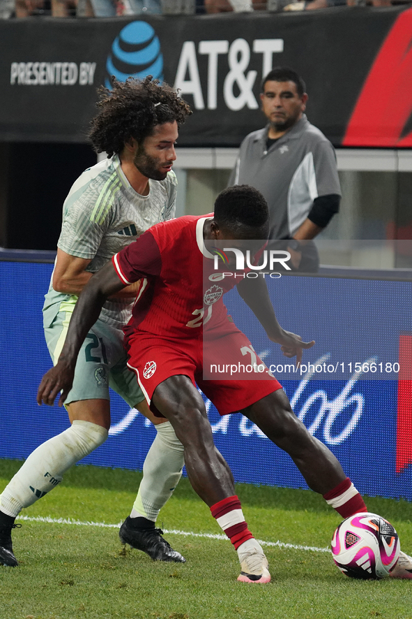 Cesar Huerta #21 of Mexico and Richie Laryea #22 of Canada battle for the ball during the international friendly match between Mexico and Ca...