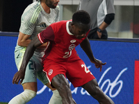 Cesar Huerta #21 of Mexico and Richie Laryea #22 of Canada battle for the ball during the international friendly match between Mexico and Ca...