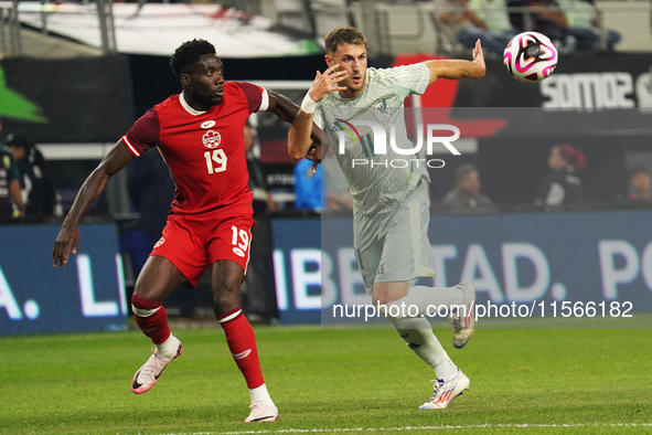 Alphonso Davies #19 of Canada and Santiago Gimenez #11 of Mexico battle for the ball during the international friendly match between Mexico...