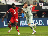 Alphonso Davies #19 of Canada and Santiago Gimenez #11 of Mexico battle for the ball during the international friendly match between Mexico...