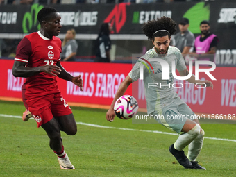 Cesar Huerta #21 of Mexico and Richie Laryea #22 of Canada battle for the ball during the international friendly match between Mexico and Ca...