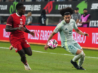 Cesar Huerta #21 of Mexico and Richie Laryea #22 of Canada battle for the ball during the international friendly match between Mexico and Ca...