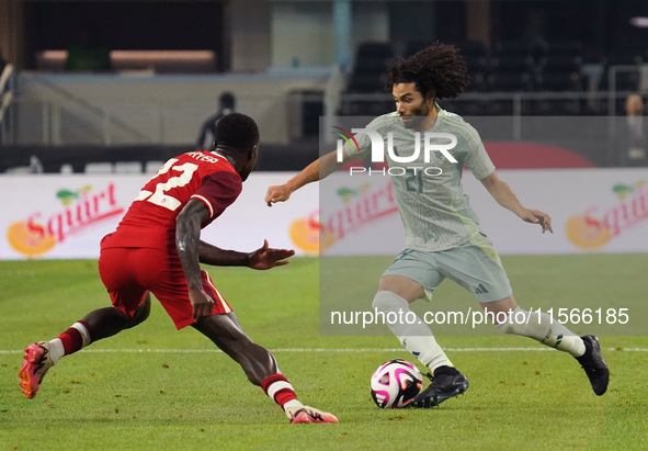 Cesar Huerta #21 of Mexico drives the ball forward during the international friendly match between Mexico and Canada at AT&T Stadium in Mexi...