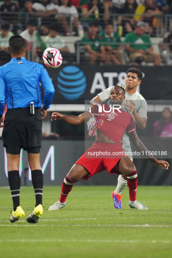 Cyle Larin #9 of Canada battles for the ball during the international friendly match between Mexico and Canada at AT&T Stadium in Mexico Cit...