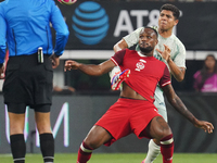 Cyle Larin #9 of Canada battles for the ball during the international friendly match between Mexico and Canada at AT&T Stadium in Mexico Cit...