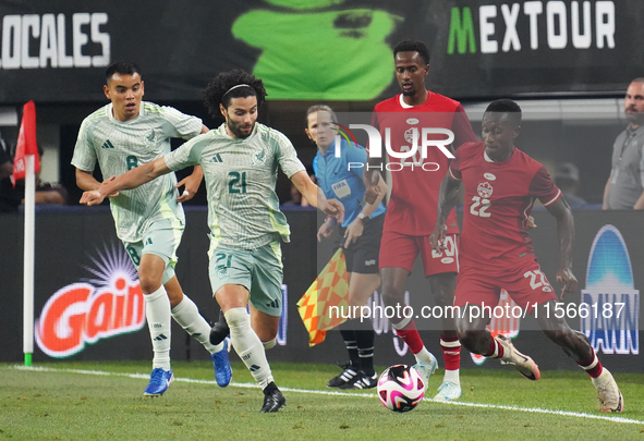 Cesar Huerta #21 of Mexico and Richie Laryea #22 of Canada battle for the ball during the international friendly match between Mexico and Ca...