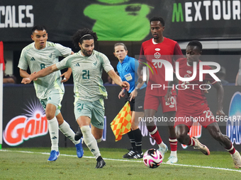 Cesar Huerta #21 of Mexico and Richie Laryea #22 of Canada battle for the ball during the international friendly match between Mexico and Ca...