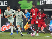 Cesar Huerta #21 of Mexico and Richie Laryea #22 of Canada battle for the ball during the international friendly match between Mexico and Ca...