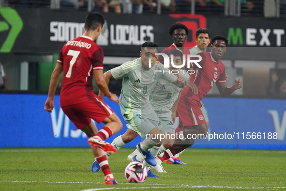 Carlos Rodriguez #8 of Mexico drives the ball forward during the international friendly match between Mexico and Canada at AT&T Stadium in M...