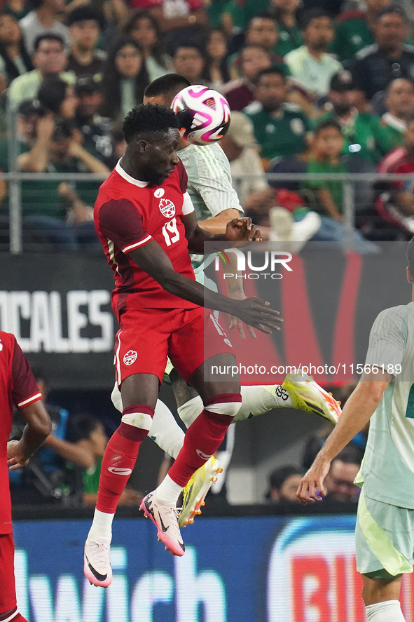 Alphonso Davies #19 of Canada jumps for the header during the international friendly match between Mexico and Canada at AT&T Stadium in Mexi...