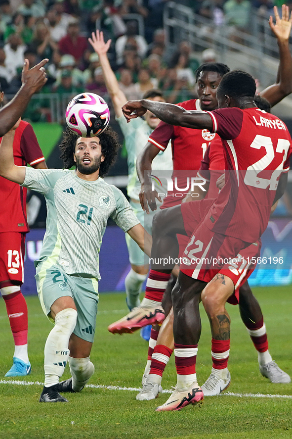 Cesar Huerta #21 of Mexico drives the ball forward during the international friendly match between Mexico and Canada at AT&T Stadium in Mexi...