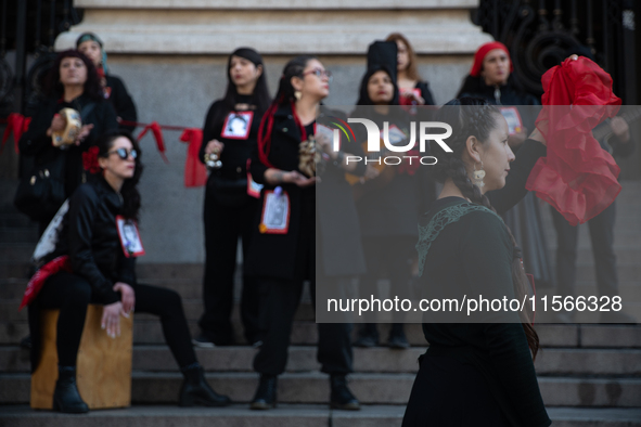 Members of the Cueca Sola collective perform an activity in front of the Palacio de La Moneda to commemorate the 51st anniversary of the Mil...