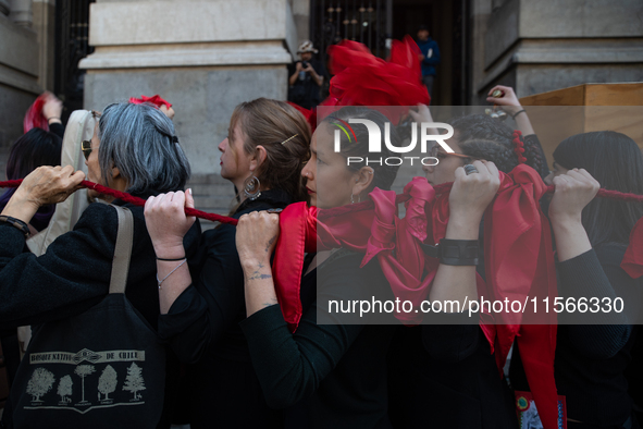 Members of the Cueca Sola collective perform an activity in front of the Palacio de La Moneda to commemorate the 51st anniversary of the Mil...